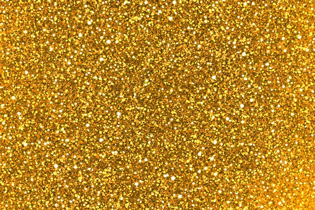 Foto goldener glitzerpulverstaub, der hintergrund platzt