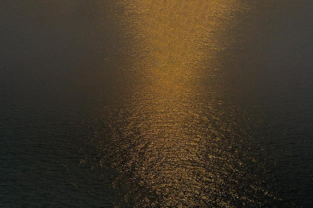 Goldenes Licht spiegelt sich auf der Wasseroberfläche.
