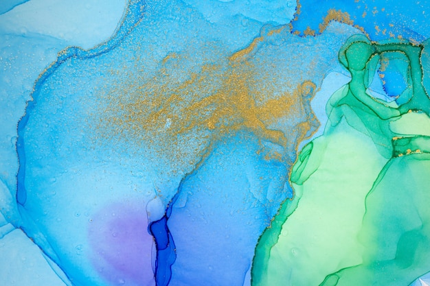 Goldfleck auf blauem und grünem Hintergrund des Aquarellverlaufs