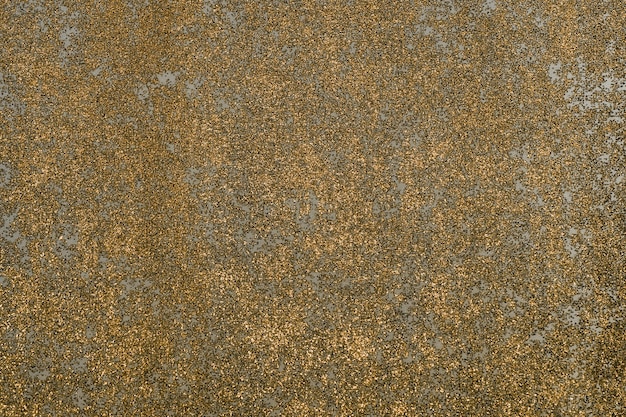 Goldglänzende Grunge-Wand-Zusammenfassungs-Hintergrund-Beschaffenheit.