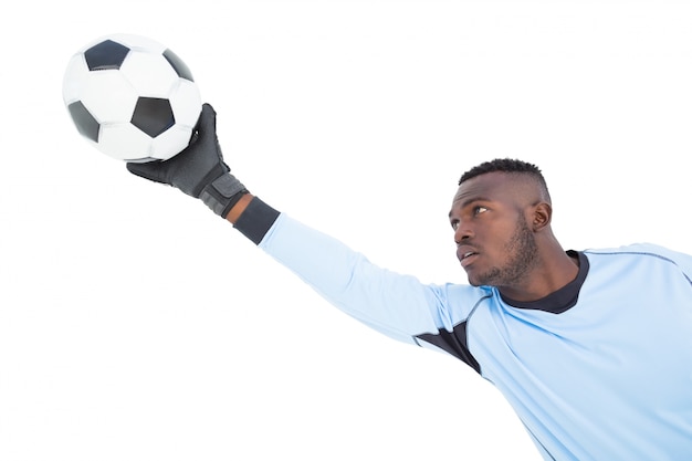 Foto goleiro em azul fazendo uma salvação