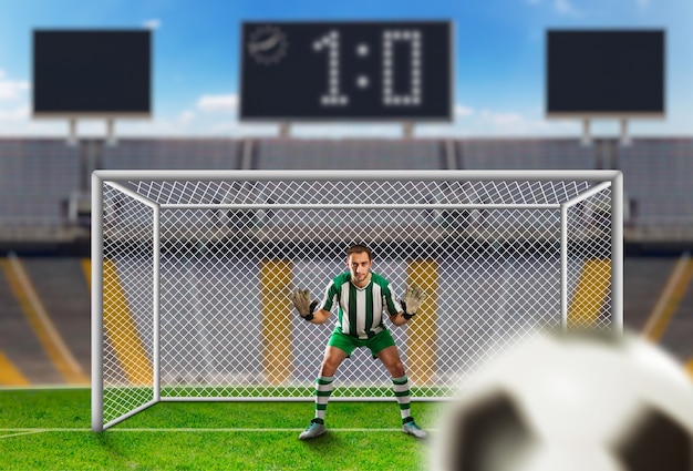 Foto goleiro pegando bola no campo de futebol