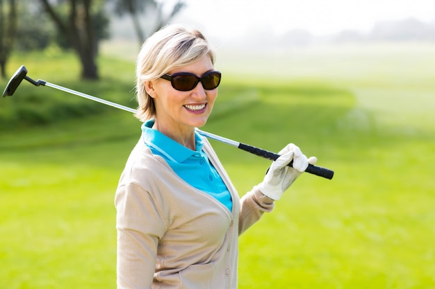 Golfista alegre que sonríe en la cámara