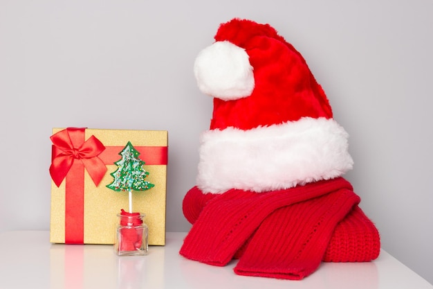 Gorro de Papá Noel, suéter de Navidad, dulces de árbol de Navidad, caja de regalo. Preparativos sorpresa navideña