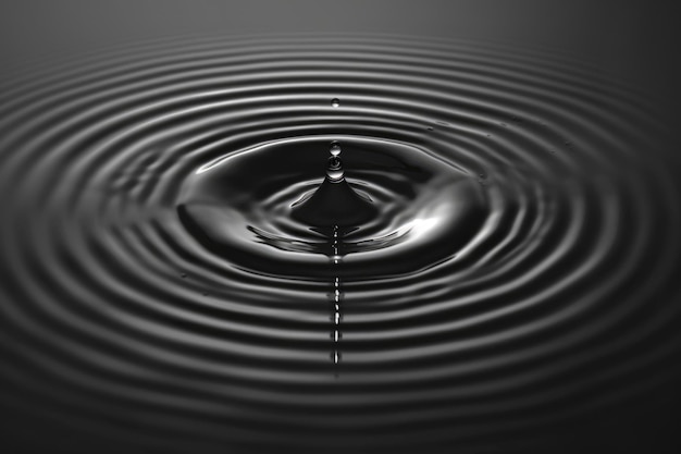 La gota de agua crea ondas oscuras y abstractas en el líquido