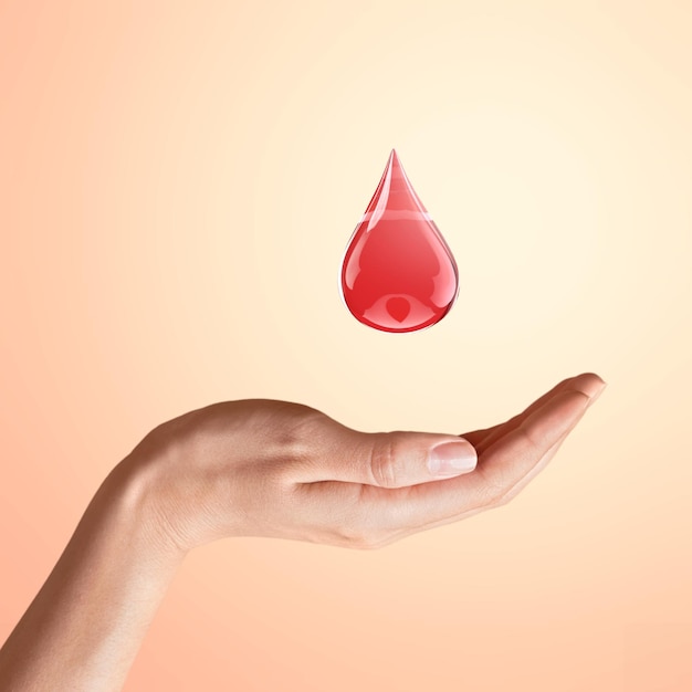 Gota de sangre humana y roja sobre un fondo. Concepto de anemia