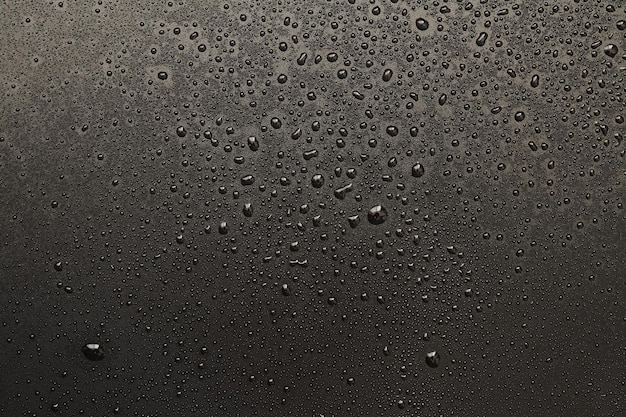 Gotas de agua sobre un fondo negro Gotas de textura de fotografía macro