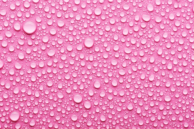 Gotas de agua sobre un fondo rosa