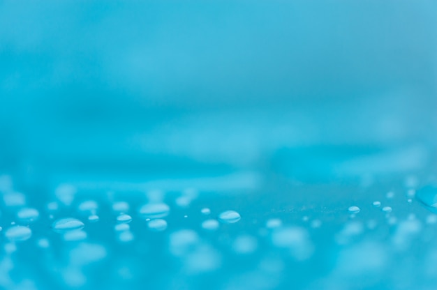 Gotas de agua sobre una superficie azul, azul. Textura sin fisuras Modelo. Fondo