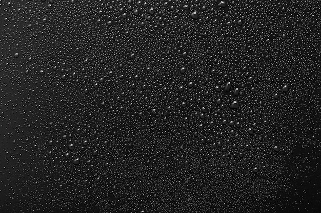 Foto gotas de agua sobre superficie negra