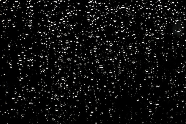 Foto gotas de chuva sobre fundo escuro de vidro