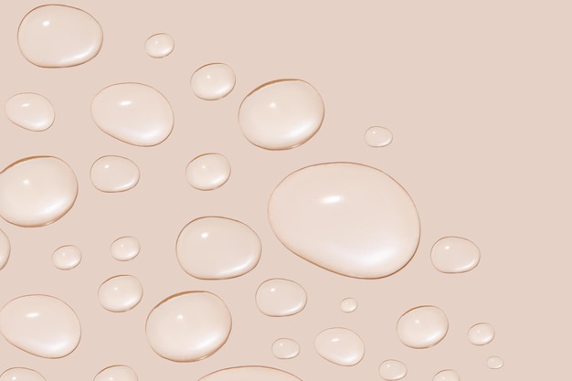 Gotas de gel transparente ou água em tamanhos diferentes Sobre um fundo bege