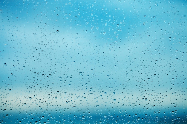 Gotas de lluvia en el cristal de la ventana transparente