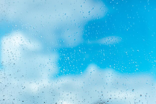 Gotas de lluvia sobre el vidrio contra el cielo nublado