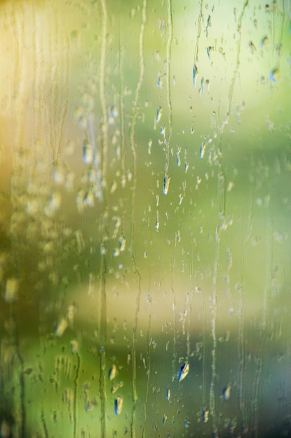 Gotas de lluvia en la superficie de los vidrios de la ventana con fondo bokeh