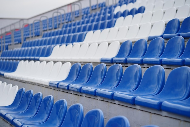 Gradas en un estadio deportivo Asientos blancos y azules en un gran estadio callejero