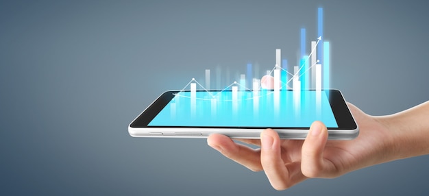 Gráfico de crecimiento y aumento de gráficos de indicadores positivos en su negocio, tableta en una mano