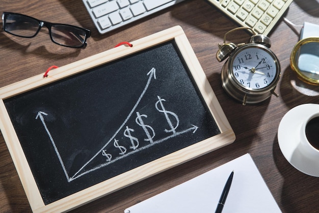 Gráfico de crecimiento del dólar en la pizarra con objetos comerciales