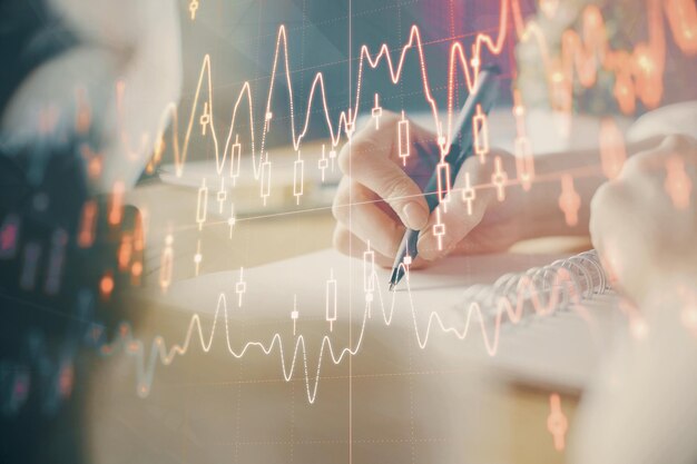 gráfico financeiro forex exibido em mãos tomando notas de fundo conceito de pesquisa exposição múltipla