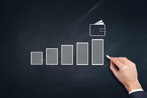 Gráfico de mano de hombre de negocios en pizarra