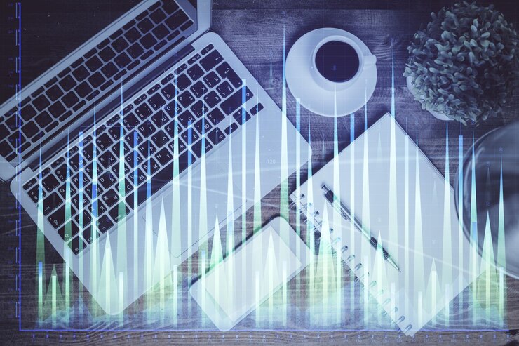 Foto gráfico del mercado financiero y vista superior de la computadora en el fondo del escritorio doble exposición concepto de inversión