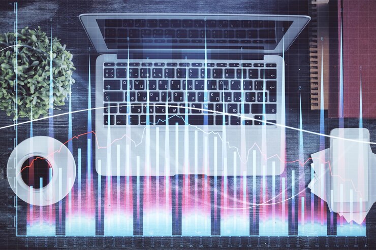 Foto gráfico del mercado de valores y computadora de vista superior en el fondo de la mesa doble exposición concepto de análisis financiero