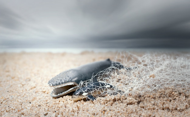 La gran ballena y el delfín bebé enredados en una red de pesca. Concepto de ecologismo y conciencia plástica