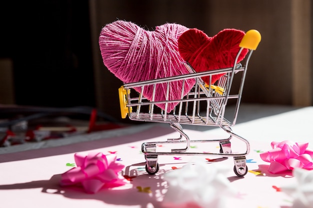 Gran corazón rojo en un carrito de compras. Concepto de compra de amor. Compras en línea de San Valentín. carro con corazones.
