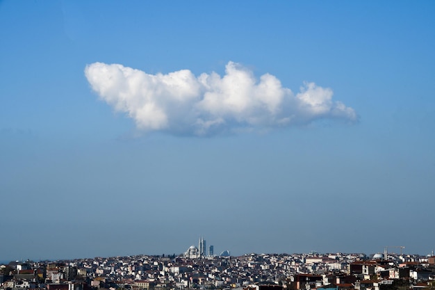 Foto gran nube blanca sobre la ciudad nube contra el cielo azul gran mezquita blanca