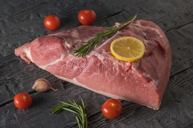 Un gran trozo de carne de cerdo preparada para hornear. Ingredientes para cocinar platos de carne.