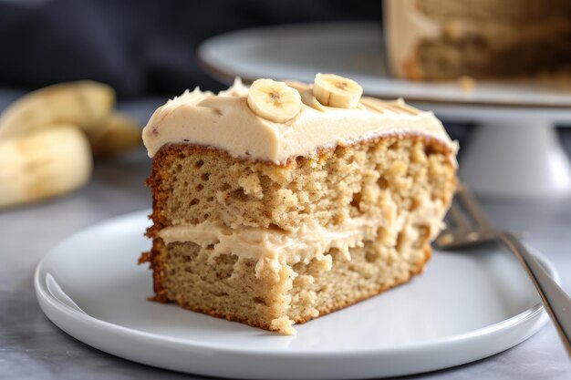 Gran trozo de pastel de plátano cubierto con glaseado cremoso de mantequilla de maní