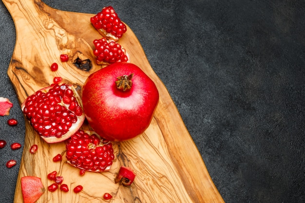 Granatapfel und Samen auf dunklem Betontisch