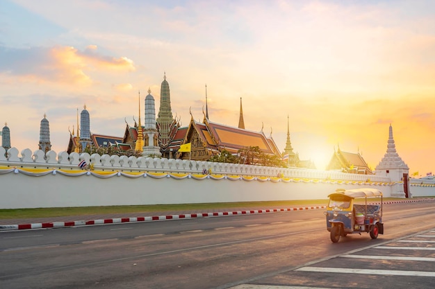 Grand Palace und Wat Phra Keaw bei Sonnenuntergang Bangkok Thailand Blue Tuk Tuk Thai traditionelles Taxi ist die vordere Szene
