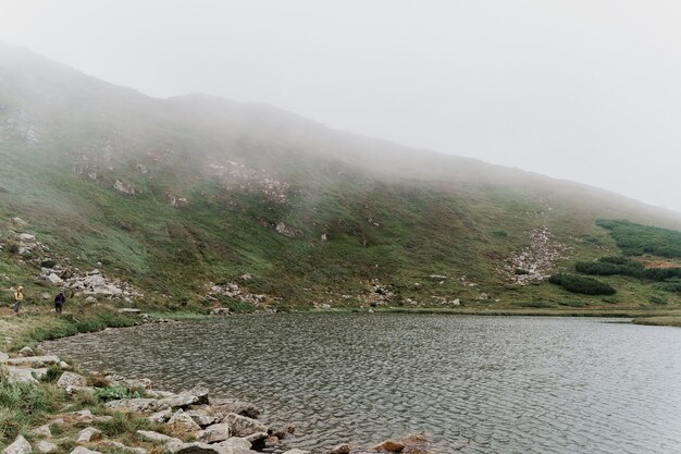 Grande lago e rochas em dia de nevoeiro