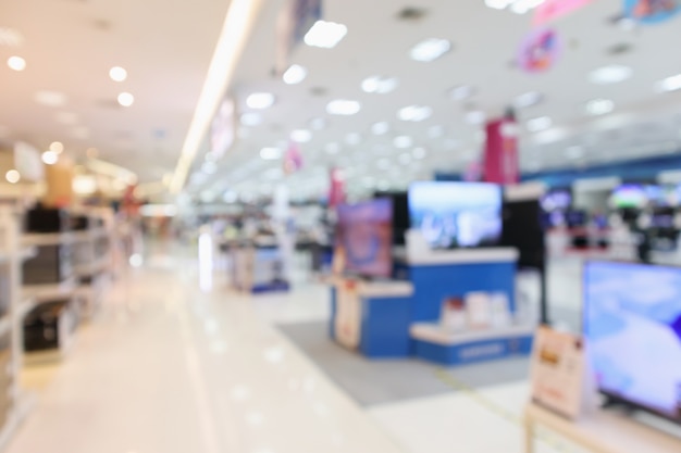 Foto los grandes almacenes electrónicos muestran televisión, televisión y electrodomésticos con luz bokeh de fondo borroso