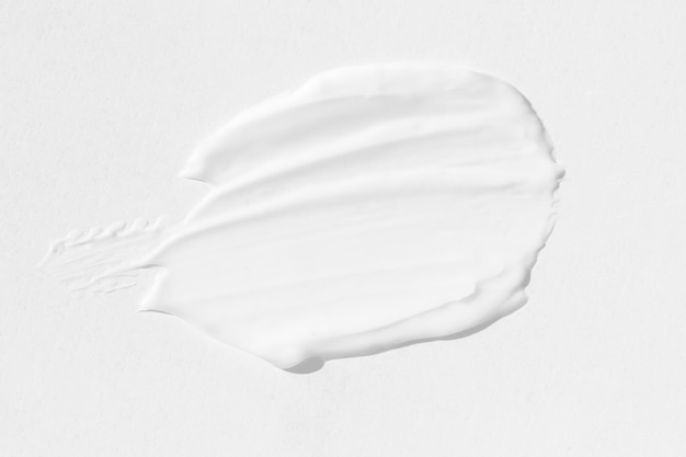 Grandes manchas de crema cosmética blanca La textura del primer plano de la crema