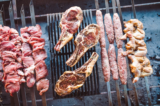 Grandes pedaços de carne em conserva em uma grade em um restaurante. Carnes grelhadas mistas.