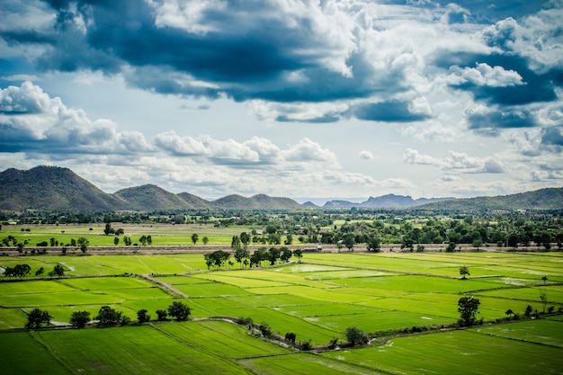 Foto granja y montaña en fondo del cielo azul