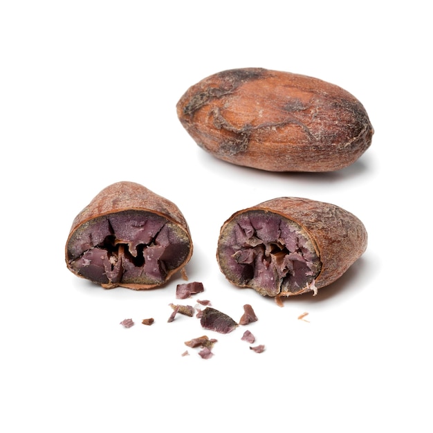 Grano de cacao entero y cortado a la mitad de cerca