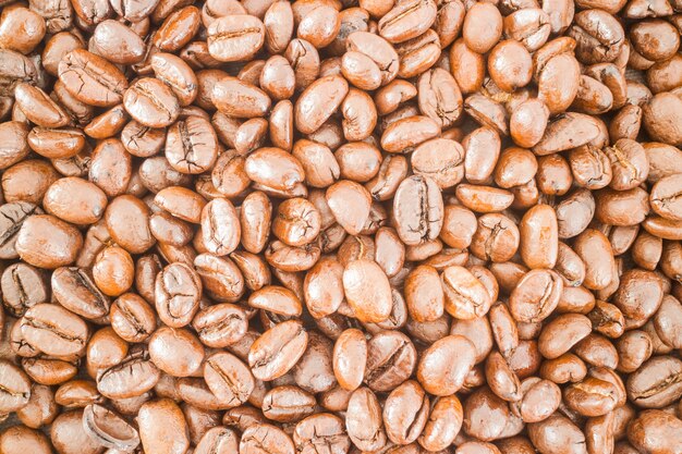 Grano de café tostado con textura de fondo