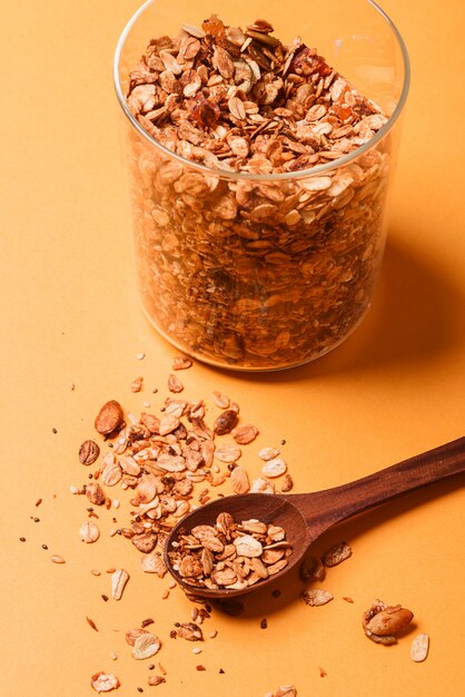 Granola in einem Glas auf einem gelben Hintergrund