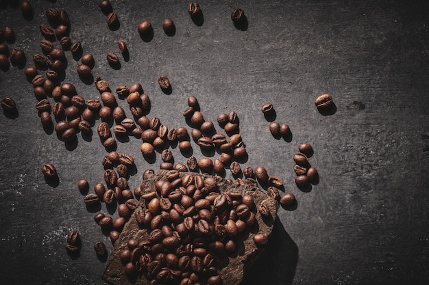 Grãos de café torrados em fundo cinza pedestal de pedra