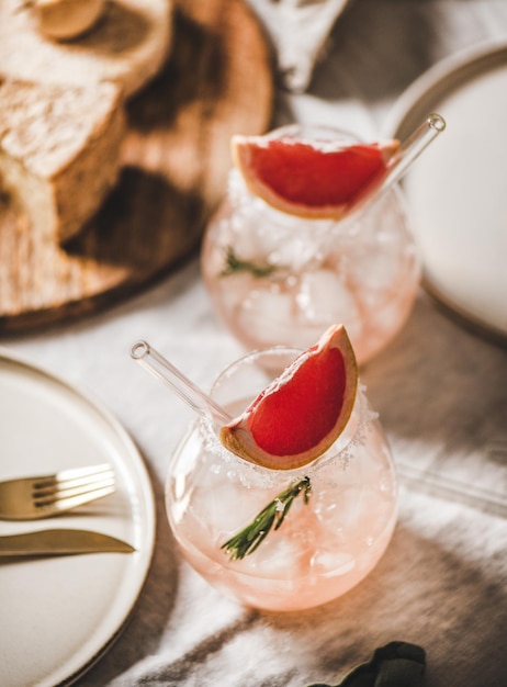 Grapefruit-Margaritas in Glaskäsebesteck und Essgeschirr auf dem Tisch