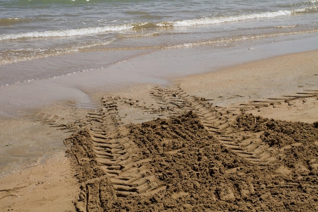 Grate und Linien im Sand von der Strandreinigungsmaschine