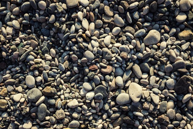 Graue Kieselsteine Strandstruktur am Meer als Hintergrund