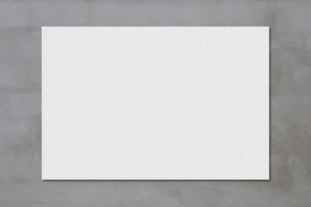 Foto graues kunstdruckpapier auf einem beton für design in ihrem arbeitskonzept.