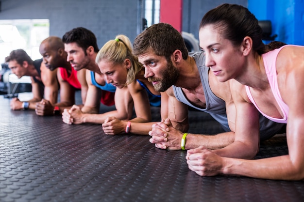 Graves amigos haciendo ejercicio en el gimnasio