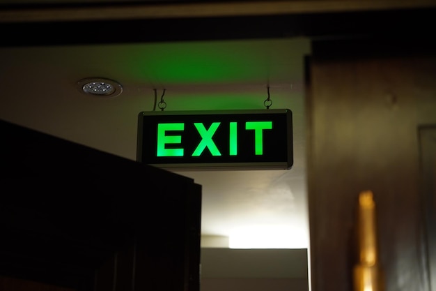 Green Exit Sign in a Dark Room