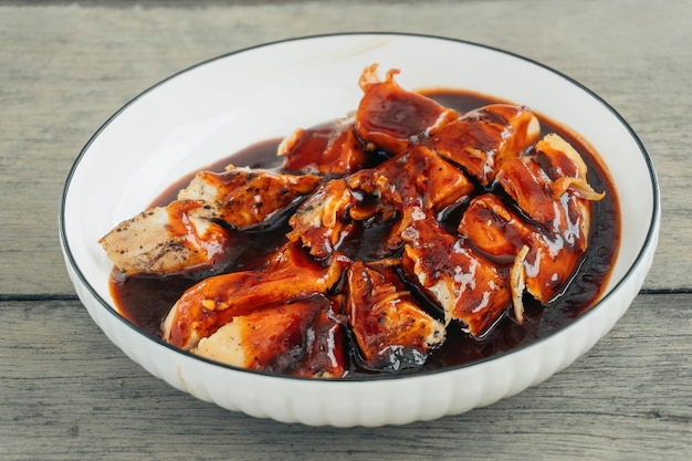 Grelhe a cozinha de churrasco de frango com fundo cinza de madeira