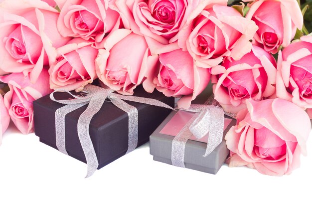 Grenze der rosa Gartenrosen mit Geschenkboxen lokalisiert auf weißem Hintergrund